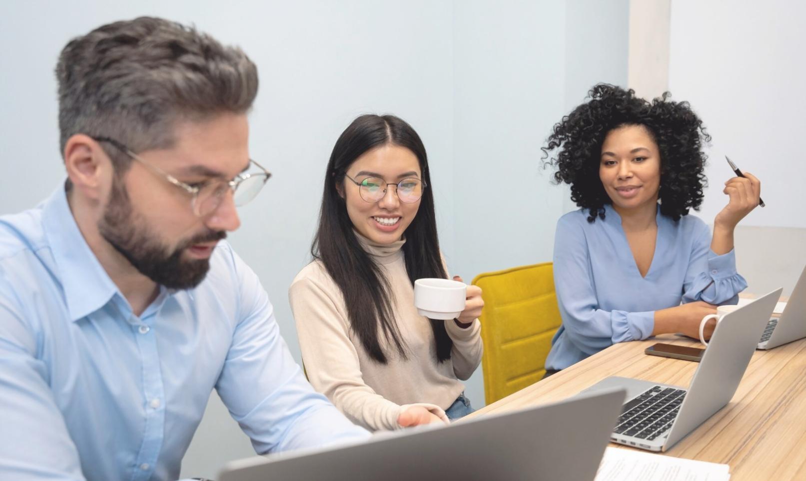 Professional analyzing complex budget spreadsheets and financial charts on multiple computer screens